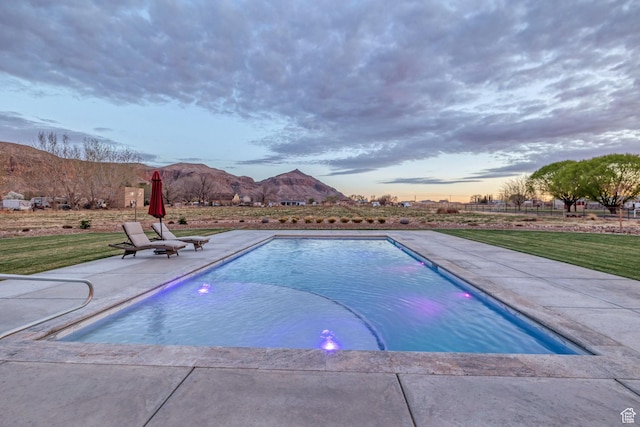 775 W 1300 S, Hurricane, UT 84737 - pool at dusk with a patio, a mountain view, and a yard