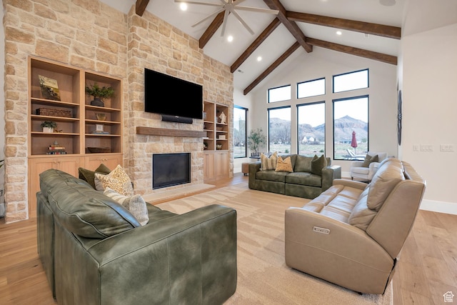775 W 1300 S, Hurricane, UT 84737 - living area featuring a stone fireplace, beam ceiling, light wood-type flooring, ceiling fan, and recessed lighting