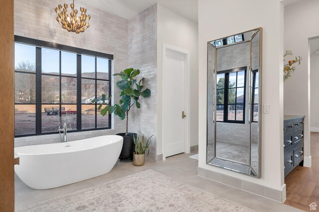 775 W 1300 S, Hurricane, UT 84737 - bathroom with a soaking tub, a chandelier, and baseboards