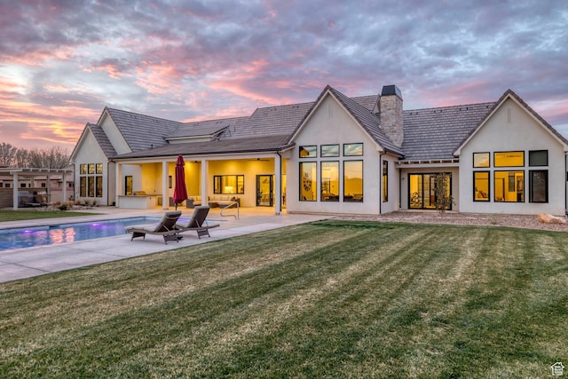 775 W 1300 S, Hurricane, UT 84737 - back of property with stucco siding, a chimney, a patio area, and a yard