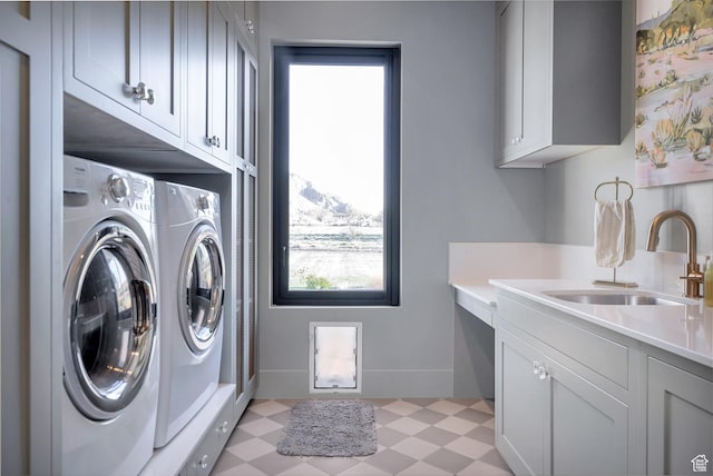 775 W 1300 S, Hurricane, UT 84737 - clothes washing area featuring cabinet space, washing machine and dryer, light floors, and plenty of natural light