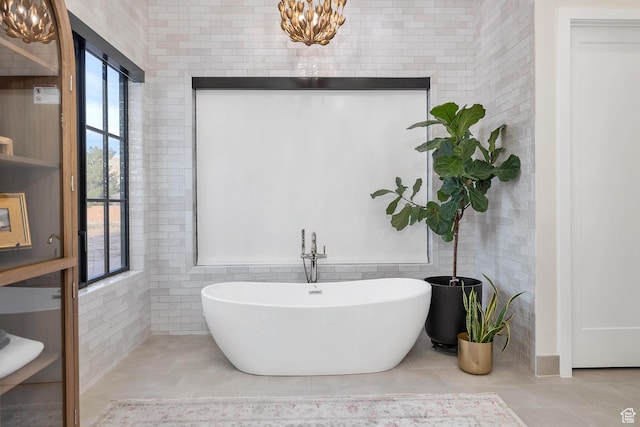 775 W 1300 S, Hurricane, UT 84737 - bathroom featuring a freestanding bath, a chandelier, tile patterned floors, and tile walls