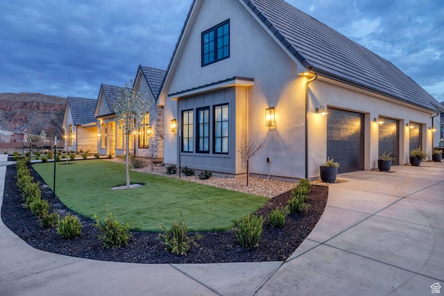 775 W 1300 S, Hurricane, UT 84737 - view of front of home with stucco siding, concrete driveway, a front lawn, and an attached garage