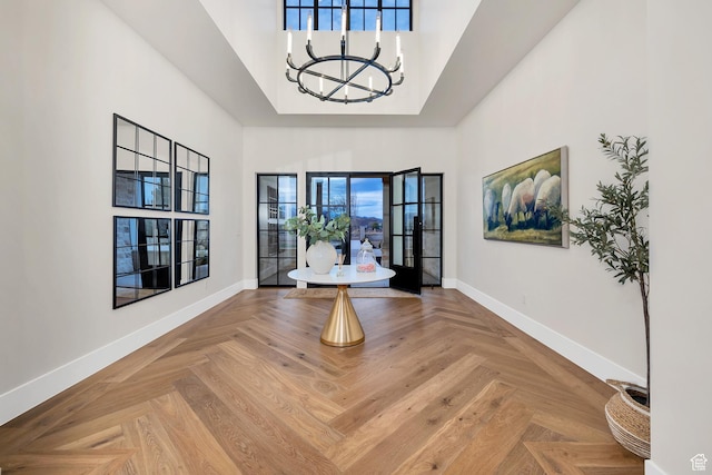 775 W 1300 S, Hurricane, UT 84737 - unfurnished dining area with a towering ceiling, baseboards, and a chandelier