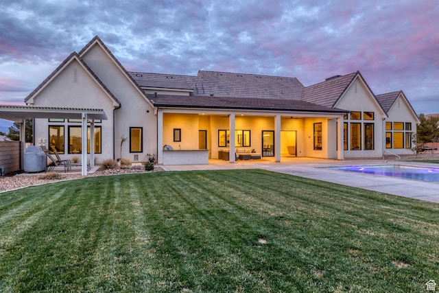 775 W 1300 S, Hurricane, UT 84737 - back of property at dusk featuring a patio, stucco siding, a lawn, and an outdoor pool