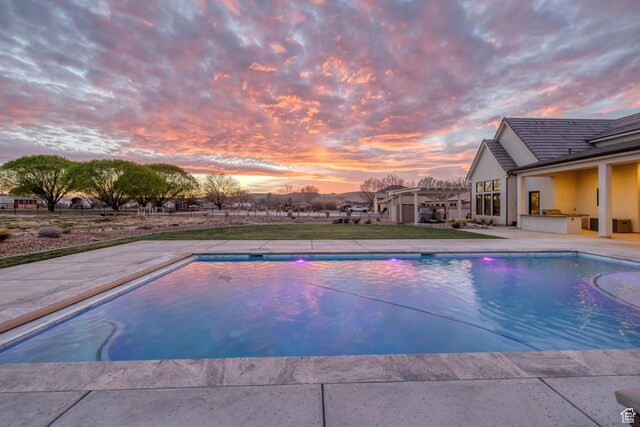 775 W 1300 S, Hurricane, UT 84737 - pool at dusk featuring an outdoor pool, a patio, and exterior kitchen