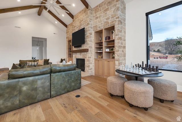 775 W 1300 S, Hurricane, UT 84737 - living area featuring a ceiling fan, wood finished floors, beamed ceiling, high vaulted ceiling, and a stone fireplace
