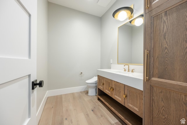 131 S Meadow Dr Unit 20, Springville, UT 84663 - half bathroom with toilet, vanity, baseboards, and wood finished floors