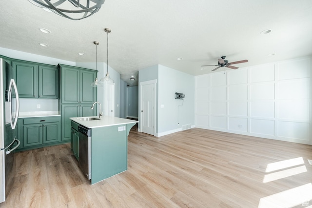 607 N Glenwilde Rd Unit 116, Vineyard, UT 84059 - kitchen with light countertops, stainless steel appliances, a sink, ceiling fan, and green cabinetry
