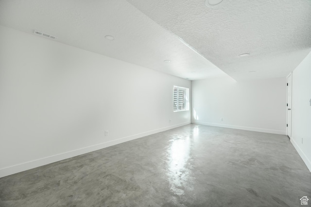 607 N Glenwilde Rd Unit 116, Vineyard, UT 84059 - empty room featuring finished concrete flooring, baseboards, visible vents, and a textured ceiling