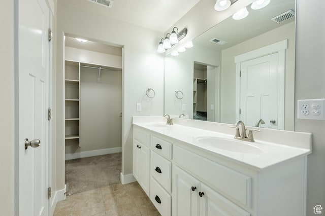 607 N Glenwilde Rd Unit 116, Vineyard, UT 84059 - bathroom with visible vents, a sink, and a walk in closet