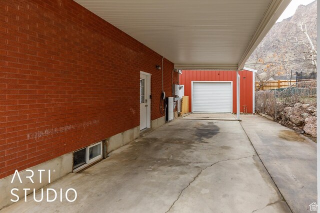 1454 E Harrop St, Ogden, UT 84404 - exterior space featuring a garage, a carport, fence, a mountain view, and concrete driveway