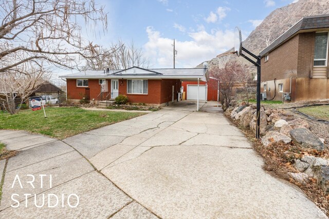 1454 E Harrop St, Ogden, UT 84404 - single story home featuring cooling unit, a front yard, brick siding, an attached garage, and concrete driveway