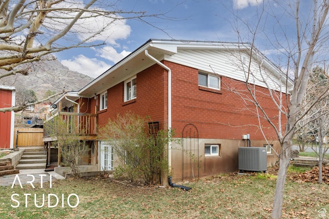 1454 E Harrop St, Ogden, UT 84404 - view of property exterior featuring brick siding, stairway, and cooling unit