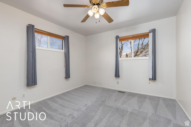 1454 E Harrop St, Ogden, UT 84404 - carpeted empty room featuring plenty of natural light, visible vents, baseboards, and a ceiling fan