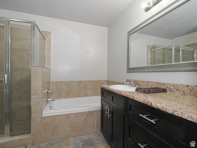 2291 E Ox Yoke Dr N, Eagle Mountain, UT 84005 - full bathroom with a stall shower, a textured ceiling, vanity, and a garden tub