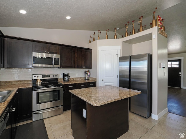 2291 E Ox Yoke Dr N, Eagle Mountain, UT 84005 - kitchen with backsplash, light stone counters, a center island, and appliances with stainless steel finishes