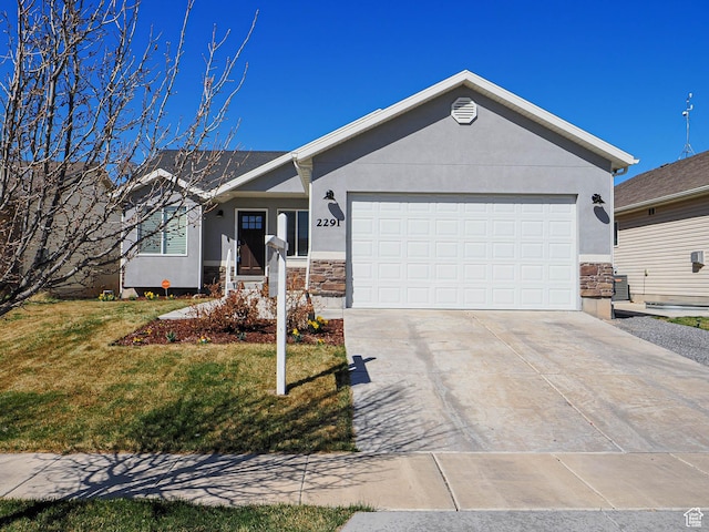 ranch-style home with concrete driveway, stucco siding, an attached garage, stone siding, and a front lawn