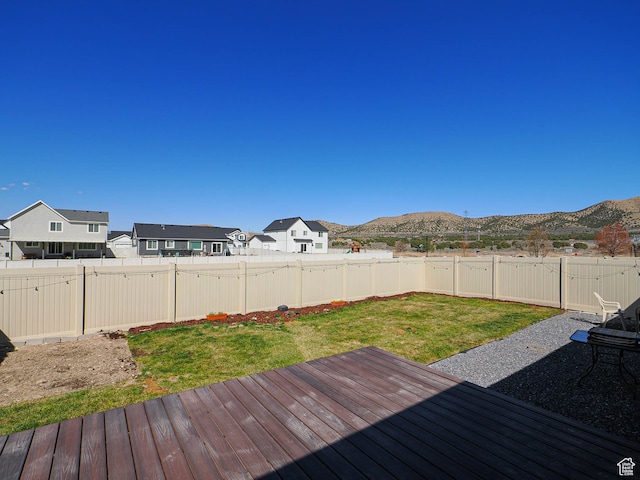 2291 E Ox Yoke Dr N, Eagle Mountain, UT 84005 - wooden terrace with a lawn, a mountain view, a fenced backyard, and a residential view