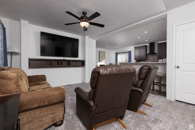 carpeted living area with recessed lighting and a ceiling fan