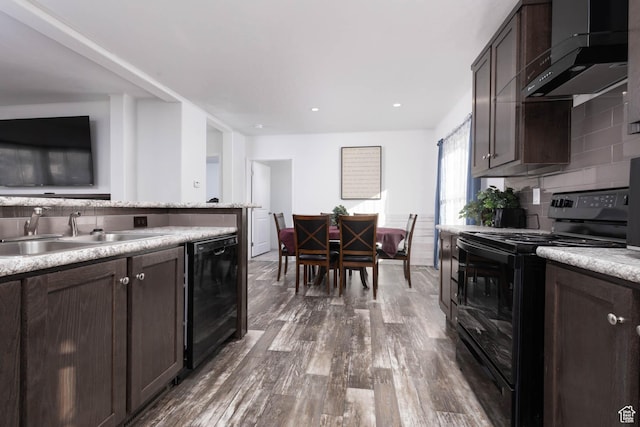 kitchen featuring black appliances, exhaust hood, a sink, and dark brown cabinets