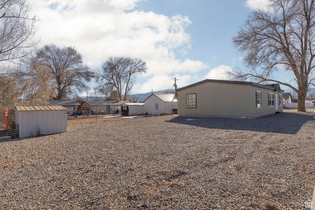 view of yard with a shed and an outbuilding