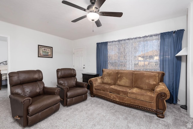 carpeted living room featuring a ceiling fan