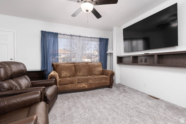 carpeted living room with visible vents and ceiling fan