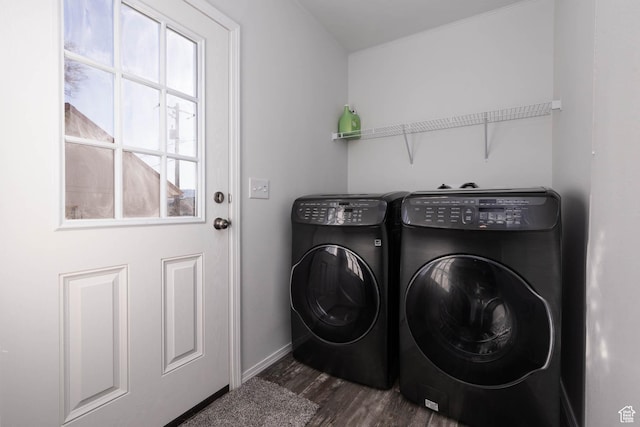 laundry area with baseboards, laundry area, washer and clothes dryer, and dark wood finished floors
