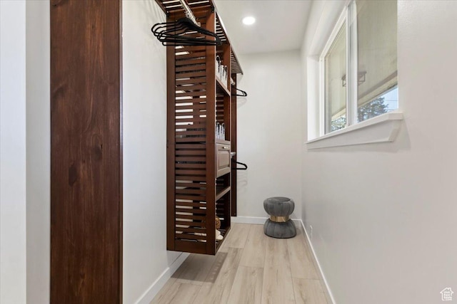 interior space with recessed lighting, baseboards, and wood finished floors