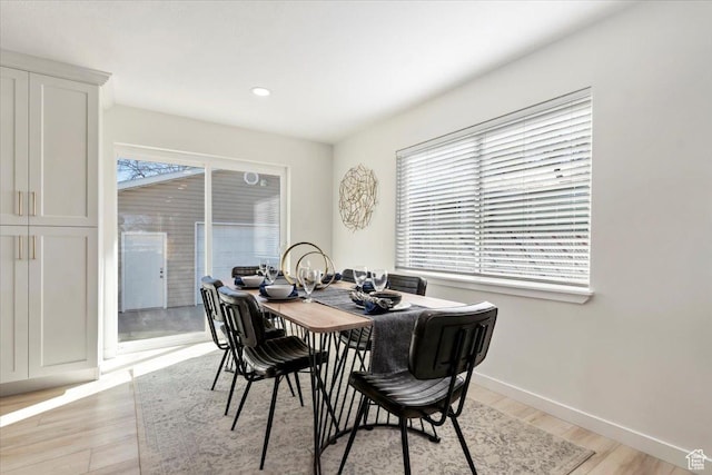 dining area with baseboards, recessed lighting, and light wood-type flooring