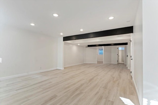 below grade area featuring baseboards, recessed lighting, and light wood finished floors