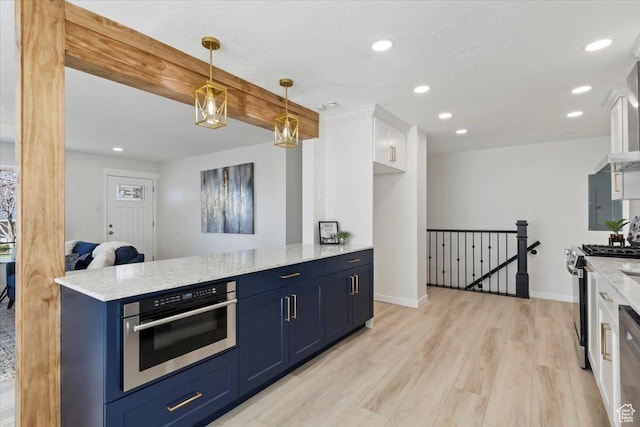 kitchen with blue cabinetry, light wood-type flooring, white cabinets, light stone countertops, and appliances with stainless steel finishes
