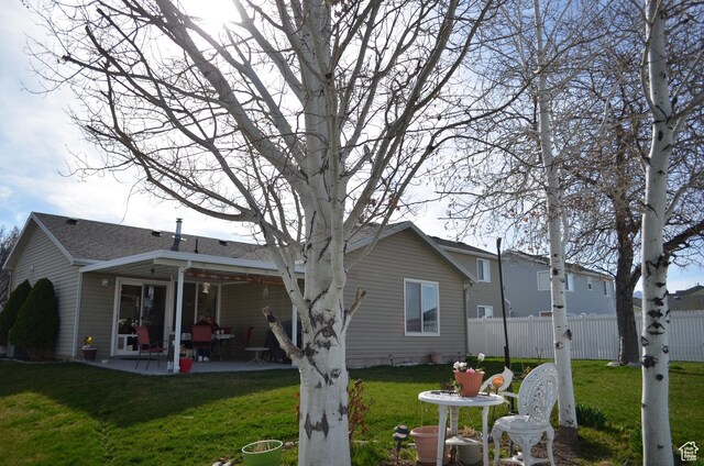 5451 N Heather Way W, Stansbury Park, UT 84074 - back of property featuring a yard, fence, and a patio