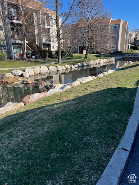 1042 E Quail Vista Ct Unit A, Millcreek, UT 84117 - view of yard featuring a garden pond