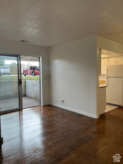 1042 E Quail Vista Ct Unit A, Millcreek, UT 84117 - empty room with wood finished floors, a textured ceiling, baseboards, and visible vents