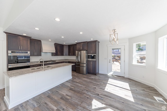 64 N Bywater Way, Brigham City, UT 84302 - kitchen with stainless steel appliances, premium range hood, a sink, dark brown cabinetry, and recessed lighting