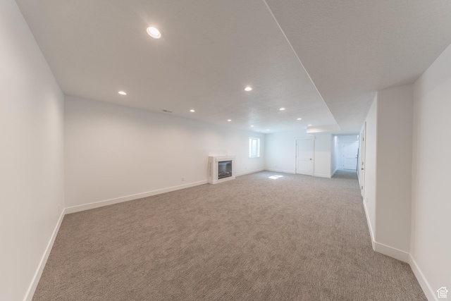 64 N Bywater Way, Brigham City, UT 84302 - unfurnished living room with carpet floors, recessed lighting, baseboards, and a glass covered fireplace
