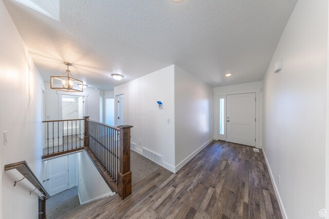 64 N Bywater Way, Brigham City, UT 84302 - corridor with an upstairs landing, wood finished floors, baseboards, a textured ceiling, and recessed lighting