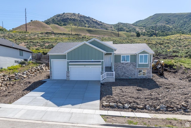 64 N Bywater Way, Brigham City, UT 84302 - single story home with board and batten siding, stone siding, a mountain view, and a garage