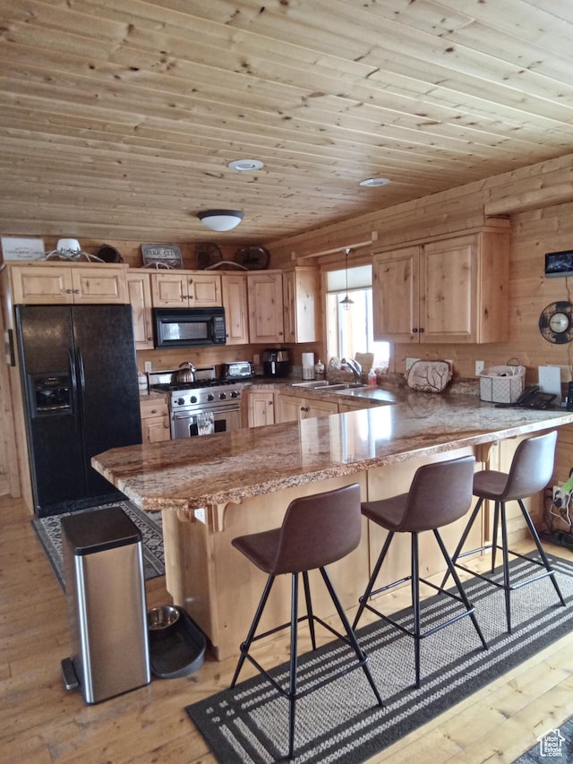 2204 S Timber Lakes Dr S Unit 945, Heber City, UT 84032 - kitchen with wood ceiling, a sink, light wood-style flooring, a peninsula, and black appliances
