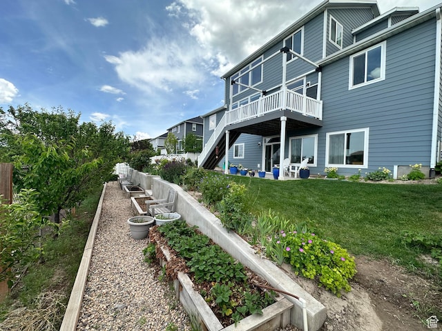 2685 E White Birch Dr, Eagle Mountain, UT 84005 - back of property with a vegetable garden and a wooden deck