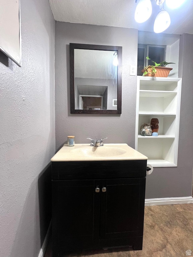 316 W 500 N, Beaver, UT 84713 - bathroom featuring vanity, built in features, baseboards, and a textured ceiling