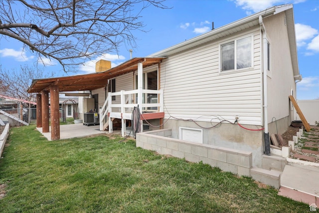 3018 S Asplund Cir, Salt Lake City, UT 84119 - rear view of house featuring a chimney, a lawn, fence, and a patio
