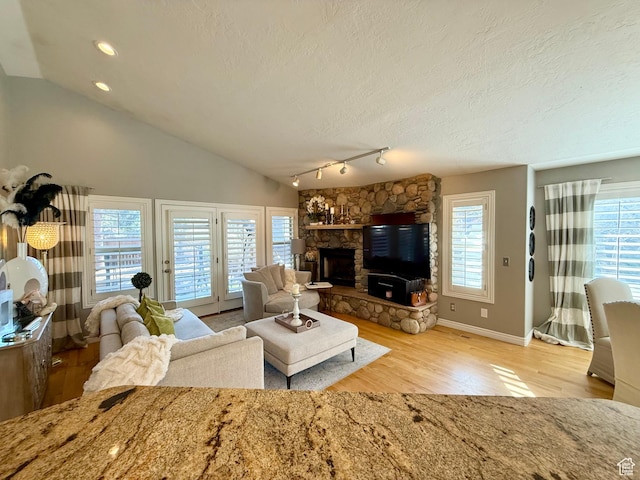 6991 S Canyon Pines Cir E, Cottonwood Heights, UT 84121 - living area with vaulted ceiling, a fireplace, wood finished floors, a textured ceiling, and recessed lighting