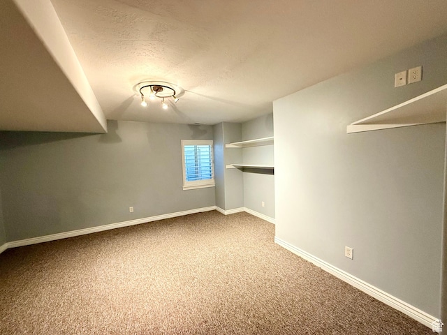 6991 S Canyon Pines Cir E, Cottonwood Heights, UT 84121 - below grade area with baseboards, carpet flooring, and a textured ceiling