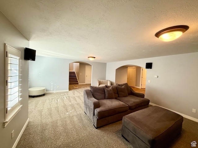 6991 S Canyon Pines Cir E, Cottonwood Heights, UT 84121 - carpeted living room featuring arched walkways, a textured ceiling, baseboards, and stairway