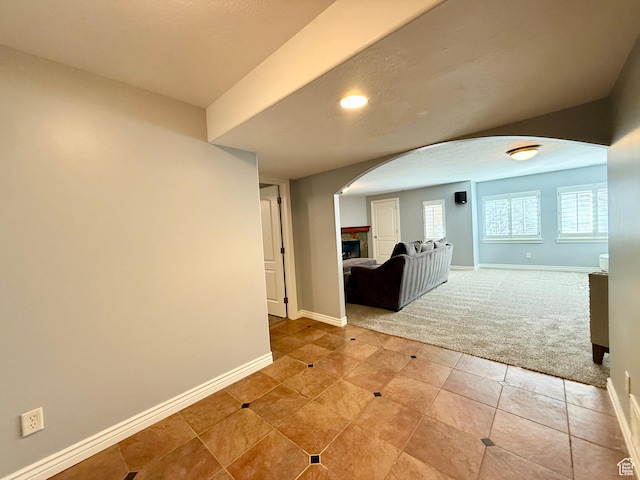 6991 S Canyon Pines Cir E, Cottonwood Heights, UT 84121 - unfurnished room featuring arched walkways, baseboards, and light carpet