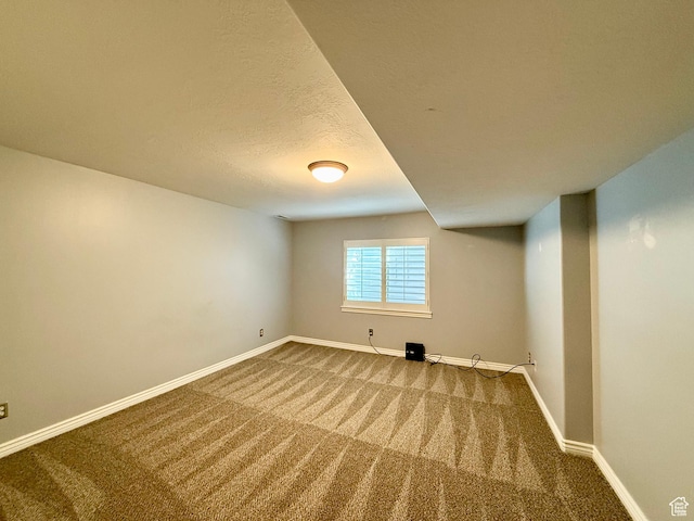 6991 S Canyon Pines Cir E, Cottonwood Heights, UT 84121 - basement featuring baseboards, carpet flooring, and a textured ceiling