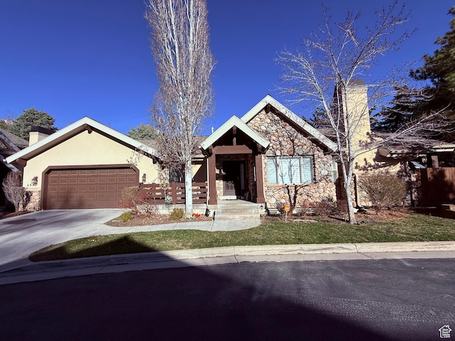 6991 S Canyon Pines Cir E, Cottonwood Heights, UT 84121 - view of front facade with stone siding, concrete driveway, a chimney, stucco siding, and a garage